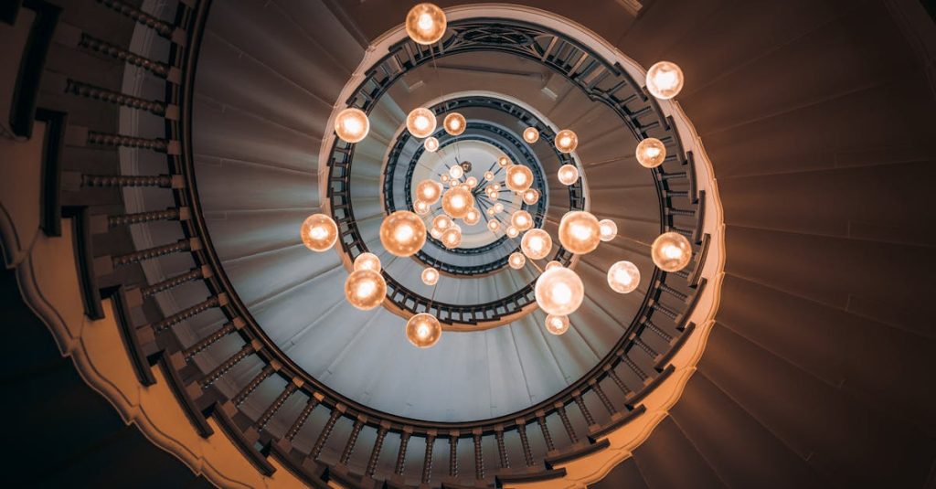 pexels-photo-10260287-10260287 Elegant spiral staircase in London with a stunning chandelier, creating a mesmerizing visual effect.
